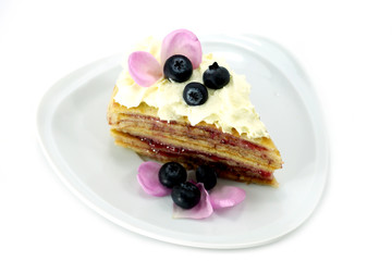 Fresh homemade crepes on plate with blueberry and strawberry jam