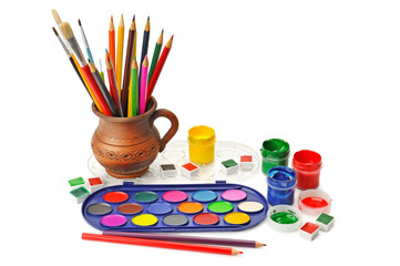 watercolor paint and colored pencils isolated on white backgroun