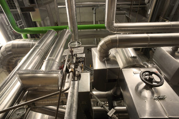 Equipment, cables and piping as found inside of a modern industr