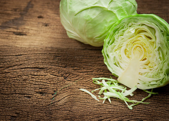 cabbage and cutted cabbage on wooden
