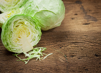 cabbage and cutted cabbage on wooden