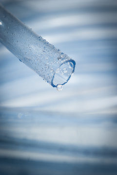 Drops Of Water Drip From Blue Garden Hose