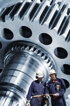 industry workers with cogwheels and gears machinery