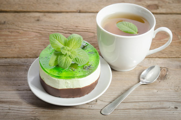 herbal tea with cake on wooden background.