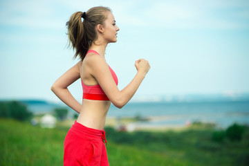 Young woman running summer park rural road. Outdoor exercises. J