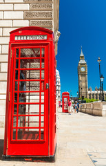 Fototapeta na wymiar Classic red phone booth of London in front of Big Ben