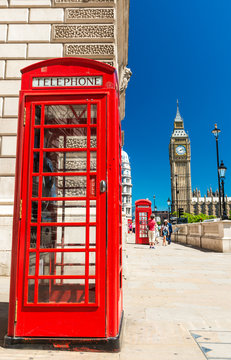 Classic red phone booth of London in front of Big Ben