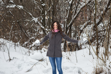 Beautiful girl throws snow