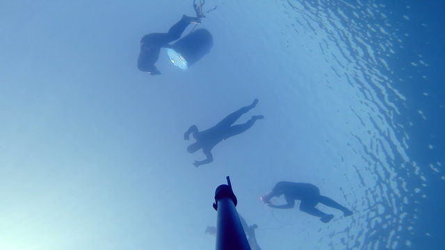 Camera Falling Down and Showing 3 Divers on the surface