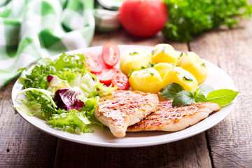plate of grilled chicken breast with vegetables