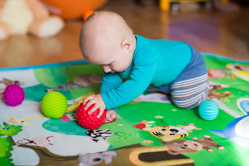 Cute little baby playing with colorful toys