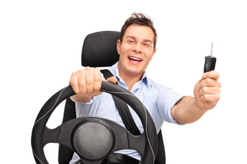 Naklejka premium Young man holding a car key