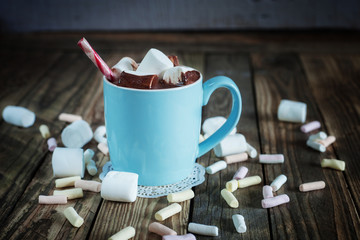 Mug filled with hot chocolate and marshmallow  and candy canes