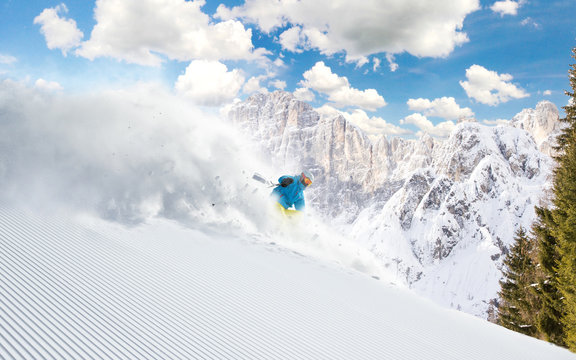 Skier skiing downhill in high mountains