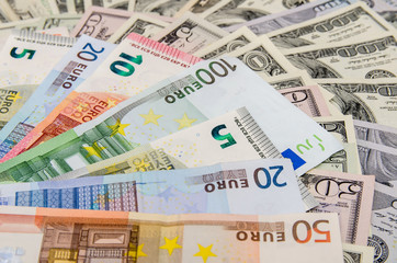 Banknotes of euros above dollars