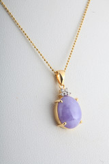 Purple Jade pendant and gold necklace isolated on white backgrou