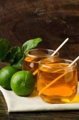 The glass of lemon tea (healthy drink) on wooden background