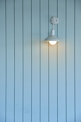 wooden wall with white lamp