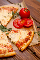 Appetizing Pizza Margherita with tomatoes on baking paper
