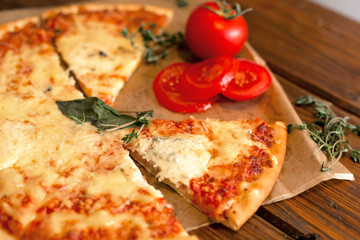 Appetizing Pizza Margherita with tomatoes on baking paper