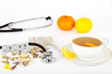 Pills and hot tea with lemon for colds and flu.