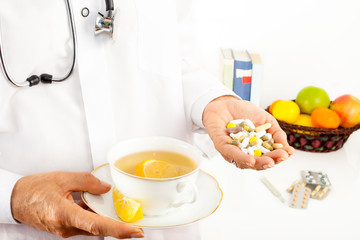 Healthcare, cold and flu treatment with tea and pills.
