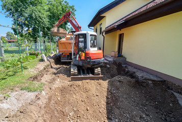 Fototapeta na wymiar A family house is being rebuilt with the help of an excavator
