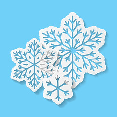 Paper snowflakes on blue background