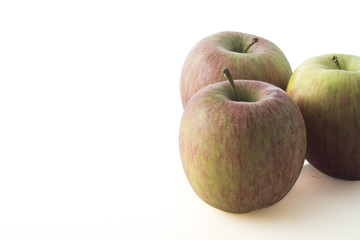 composition of three biological red apples on white background
