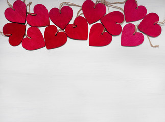 Red wooden hearts on wooden background