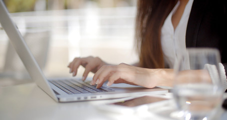 Businesswoman typing on a laptop computer