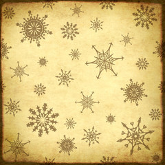 Background of the old, soiled paper and snowflakes pattern