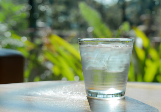 Glass water,Ice glass on green background.