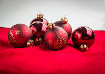 Red christmas balls on red background