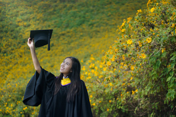 asian graduate in Mexican Sunflower field