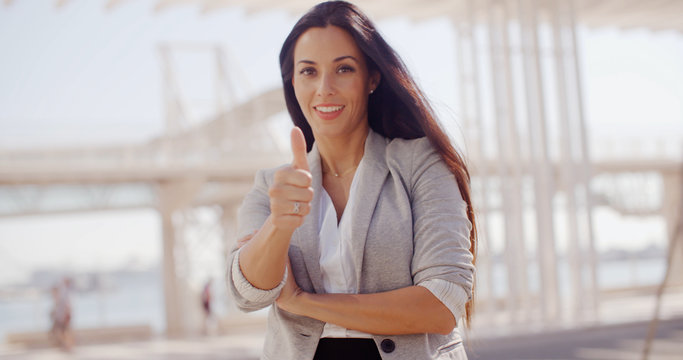 Motivated young woman giving a thumbs up