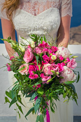 Bride in white dress with bouquet of flowers