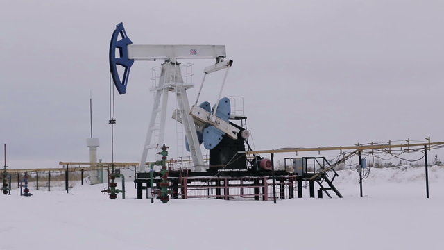 Oil and gas industry. Work of oil pump jack on a oil field. 