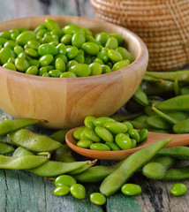 green soy beans in the wood bowl on table