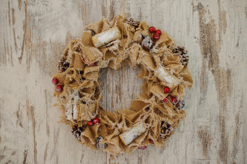 Christmas wreath made of canvas  on wooden background