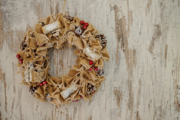 Christmas wreath made of canvas  on wooden background