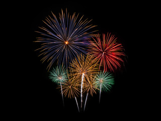Colorful fireworks of various colors on black background