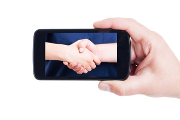 Medical handshake picture on cellphone screen