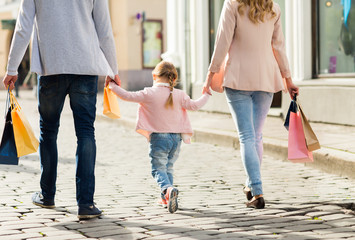close up of family with child shopping in city