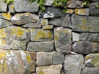 A beautiful stone wall made by square stones well fit together