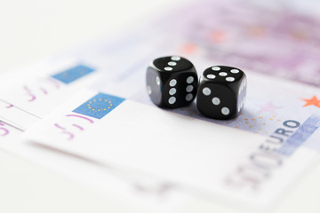 close up of black dice and euro cash money