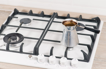 Close-up of brewing coffee in the turk. shallow DOF