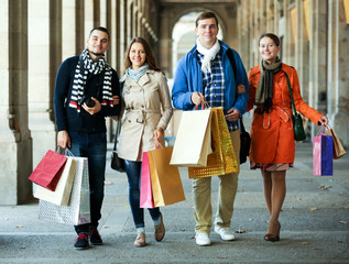 Group of young tourists with purchases