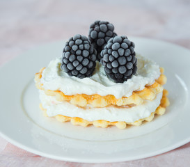 Waffles with blackberries and soft cheese