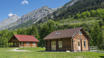 Fototapeta na wymiar Wooden cottages in the Alps